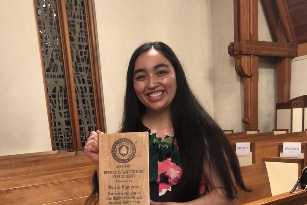 Rocio Figueroa ’22 holding an award in the chapel