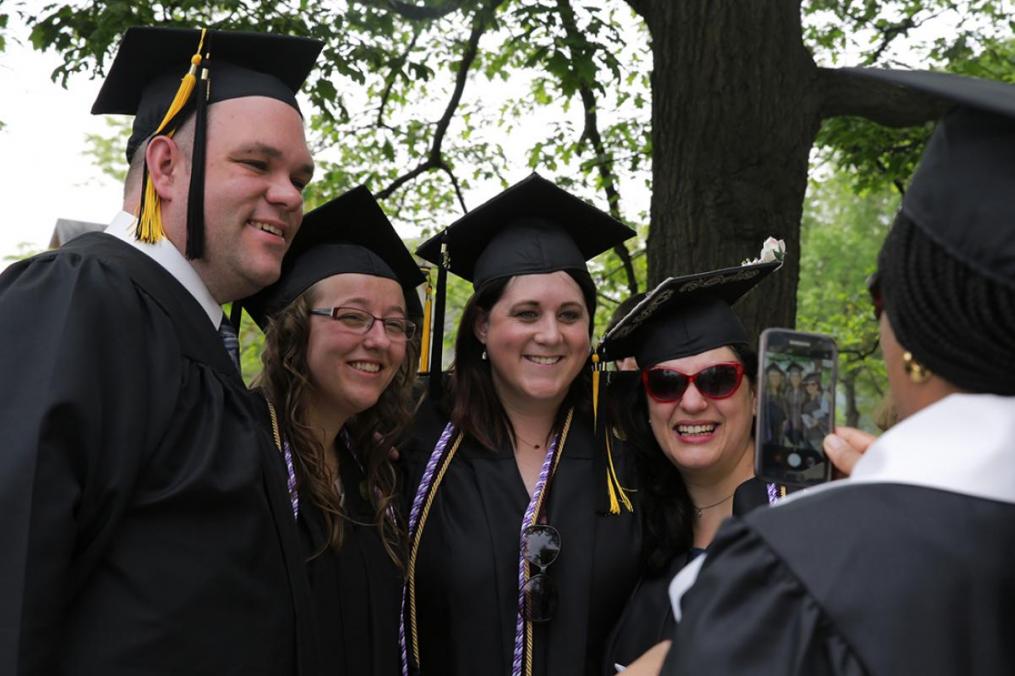 Newly minted ASAP graduates smile for the camera.